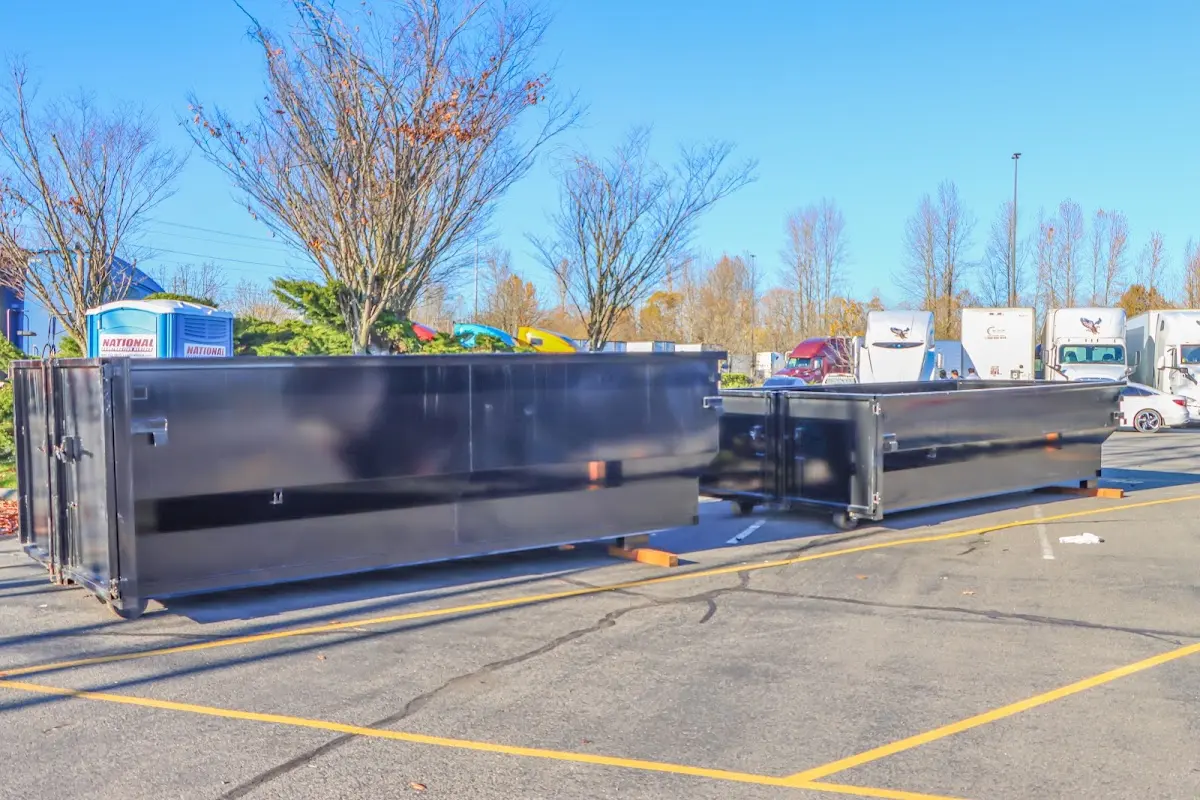 Professional dumpster rental service with roll-off container on residential driveway in West Sacramento